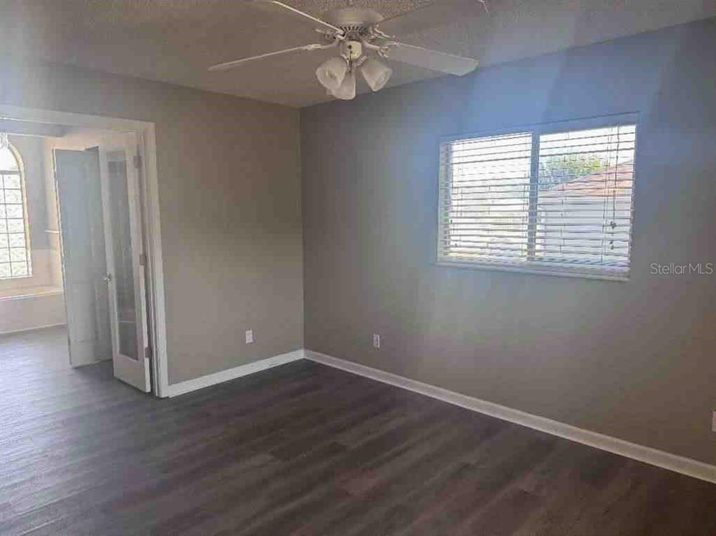 5110 Northwest 19th Place Ocala, FL 34482 - Photo 9 of 9 an empty room with wooden floor and windows