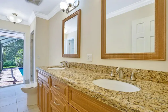 a view of a backyard with table and chairs under an umbrella