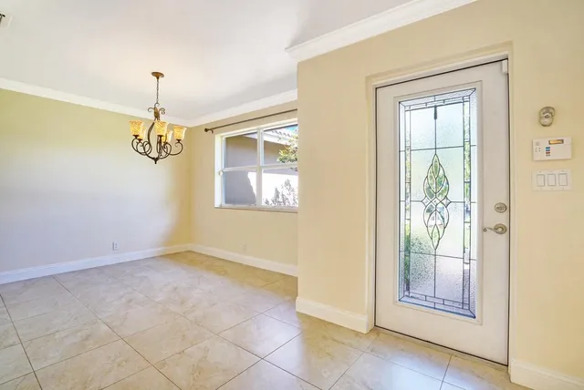 a living room with furniture a flat screen tv and a large window