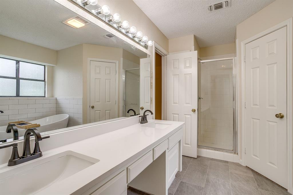 8613 Silver Creek Road White Settlement, TX 76108 - Photo 15 of 40 a bathroom with a sink double vanity and a mirror