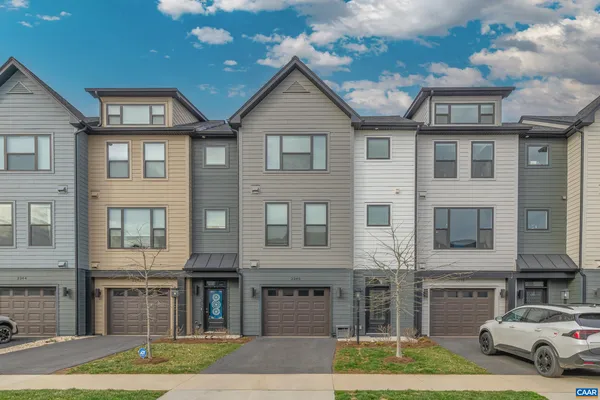 a front view of a residential apartment building with a yard