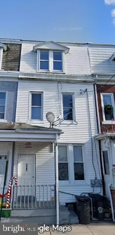 a kitchen with a sink and a refrigerator