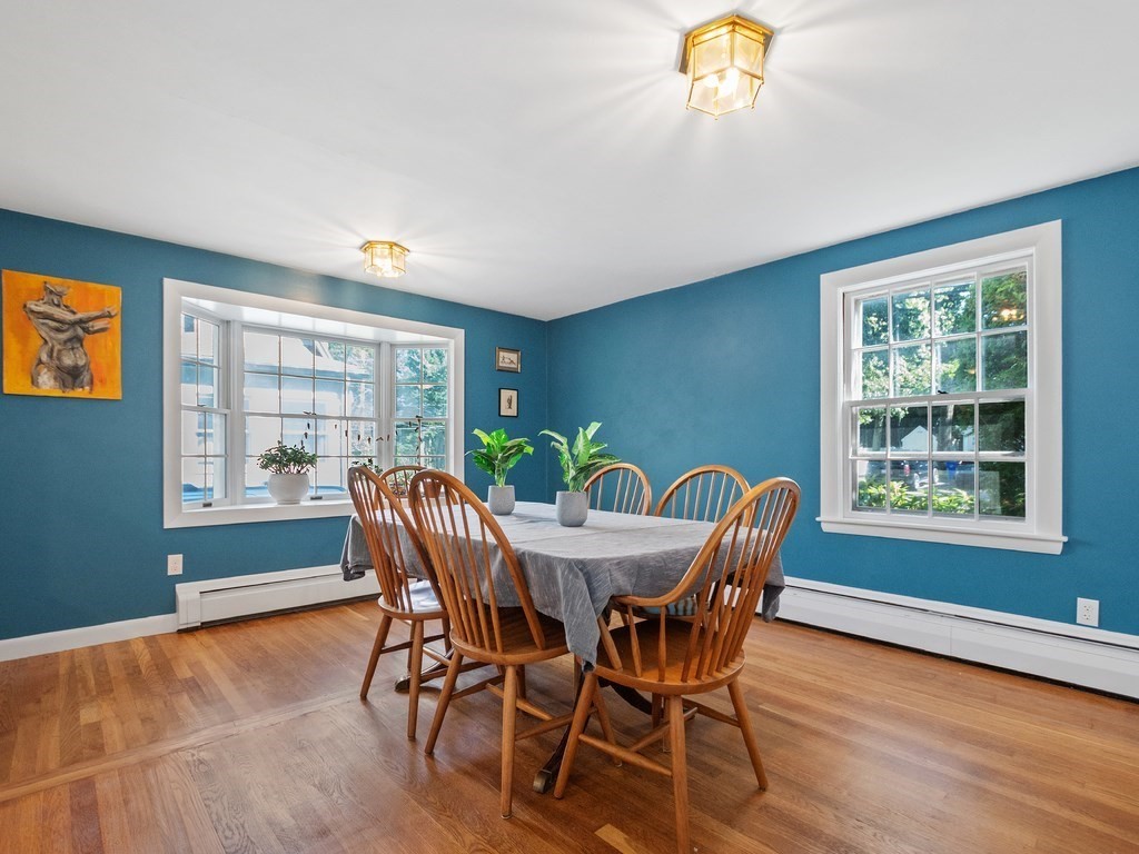 59 Harland Road Waltham, MA 02453 - Photo 14 of 39 a view of a dining room with furniture a livingroom and wooden floor