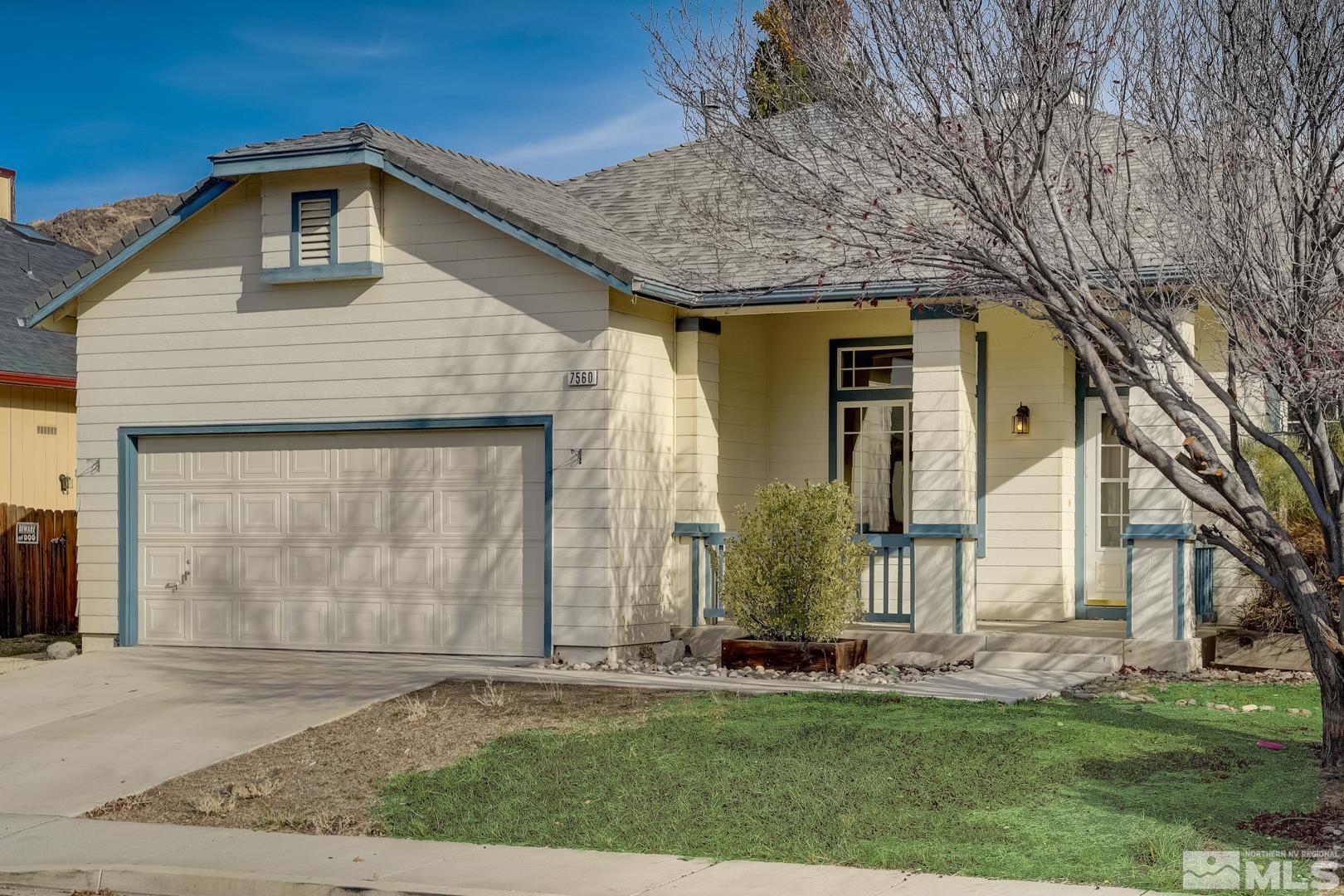 7560 Michaela Drive Reno, NV 89511 - Photo 11 of 32 a front view of a house with a yard