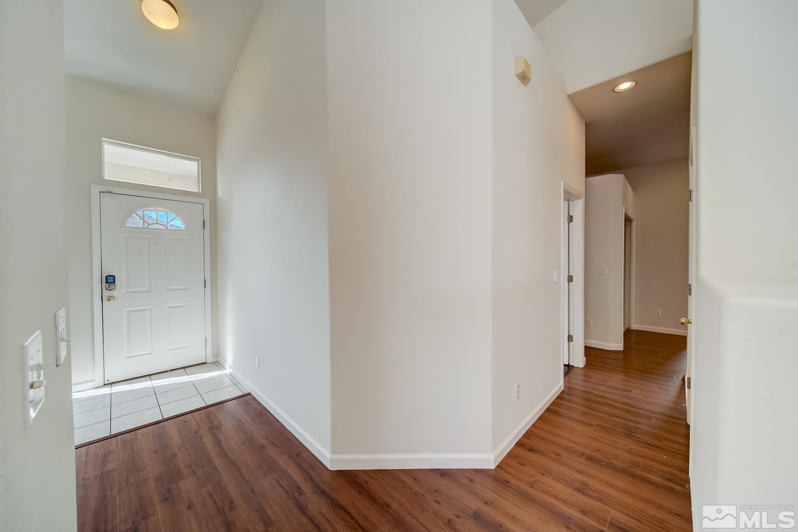 7560 Michaela Drive Reno, NV 89511 - Photo 13 of 32 a view of a hallway with wooden floor