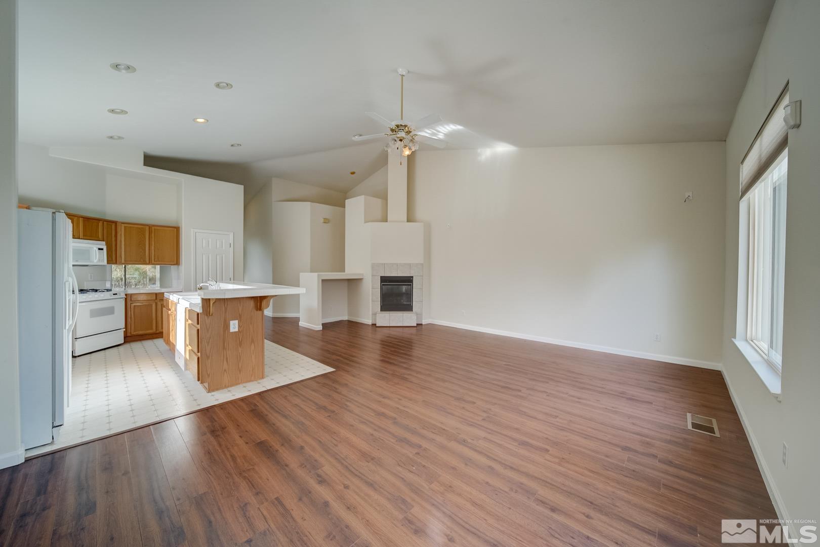 7560 Michaela Drive Reno, NV 89511 - Photo 15 of 32 a view of a kitchen with a sink a refrigerator and a fireplace
