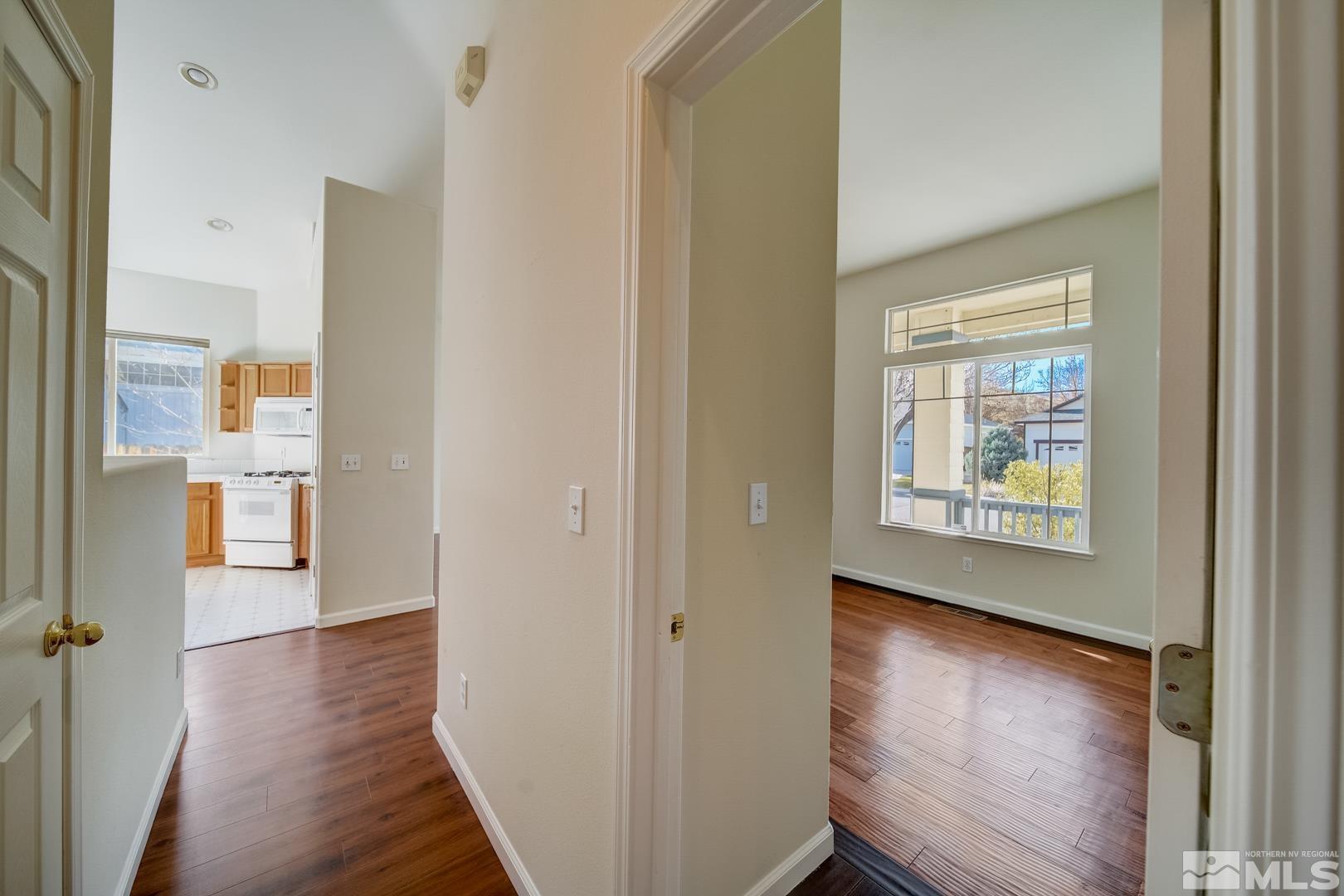 7560 Michaela Drive Reno, NV 89511 - Photo 16 of 32 a view of hallway with a large window and wooden floor