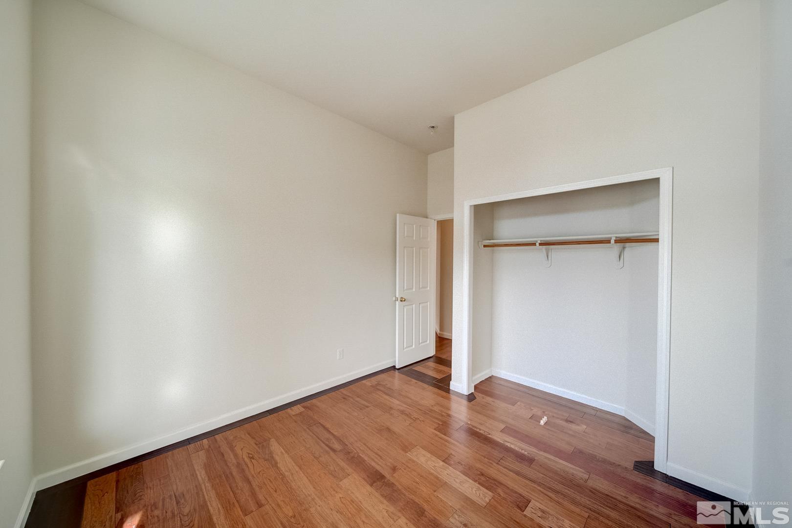 7560 Michaela Drive Reno, NV 89511 - Photo 18 of 32 a view of an empty room with wooden floor and closet