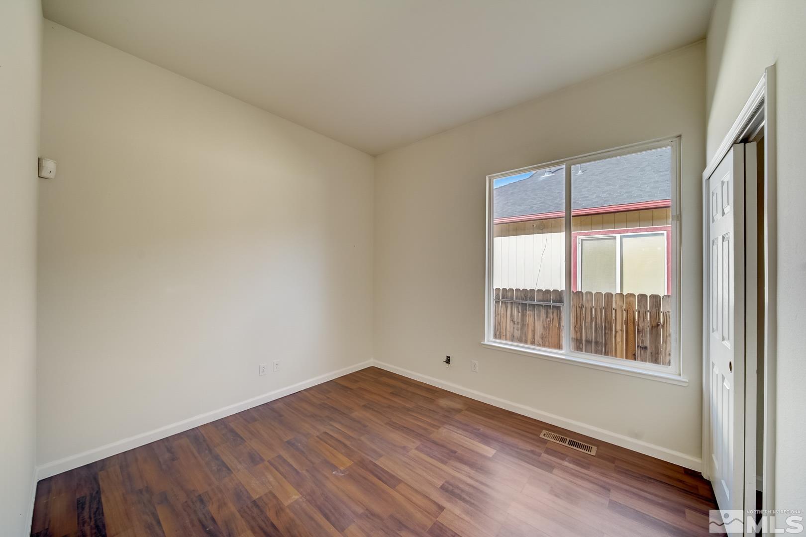 7560 Michaela Drive Reno, NV 89511 - Photo 21 of 32 a view of empty room with wooden floor and fan