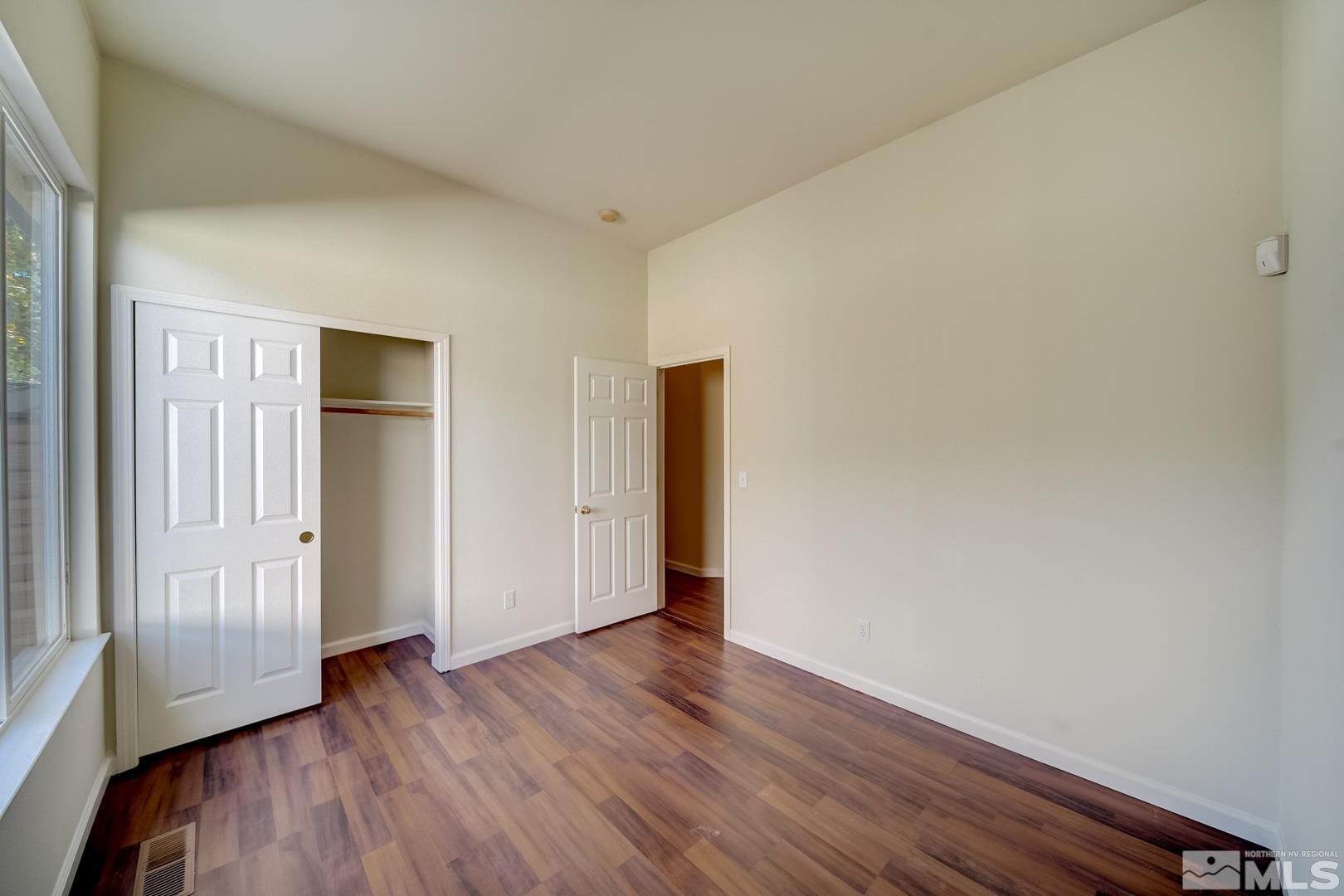 7560 Michaela Drive Reno, NV 89511 - Photo 22 of 32 a view of an empty room with wooden floor