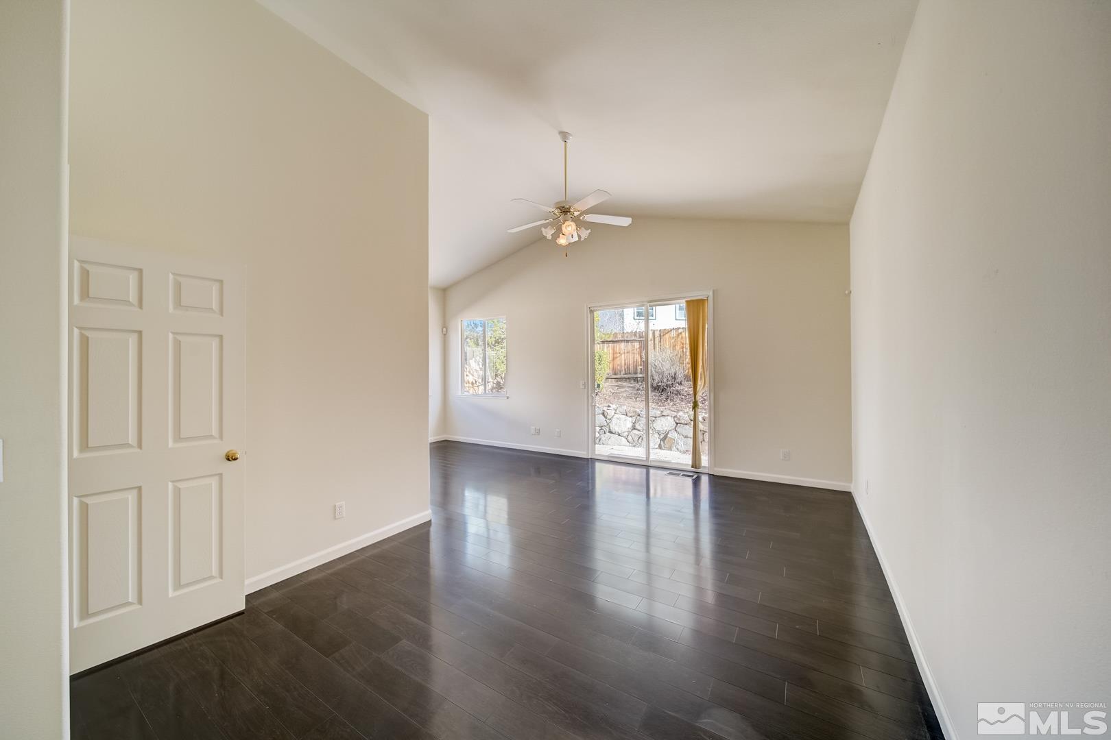 7560 Michaela Drive Reno, NV 89511 - Photo 24 of 32 an empty room with wooden floor and windows