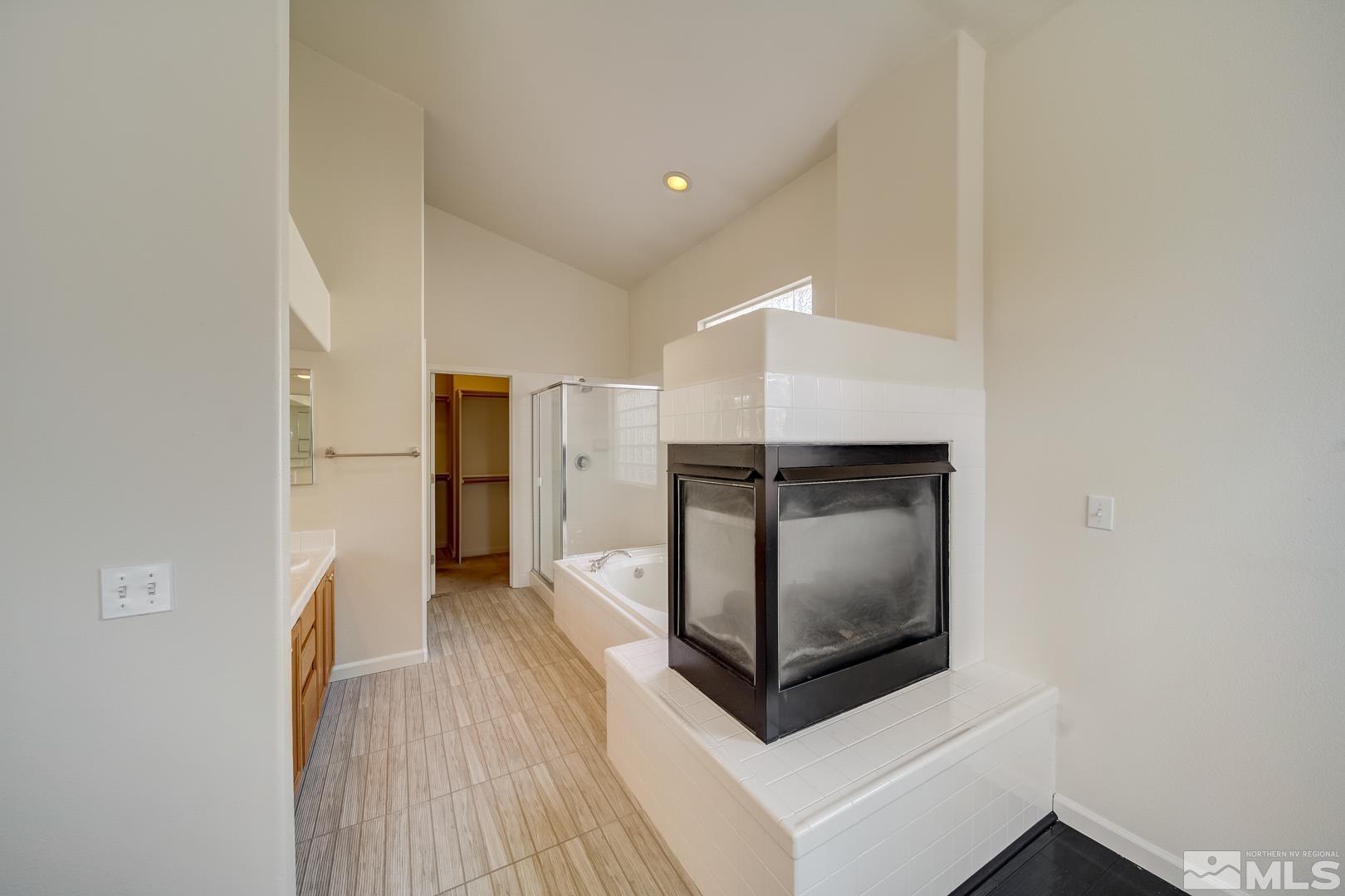 7560 Michaela Drive Reno, NV 89511 - Photo 27 of 32 a view of hallway with cabinets and wooden floor