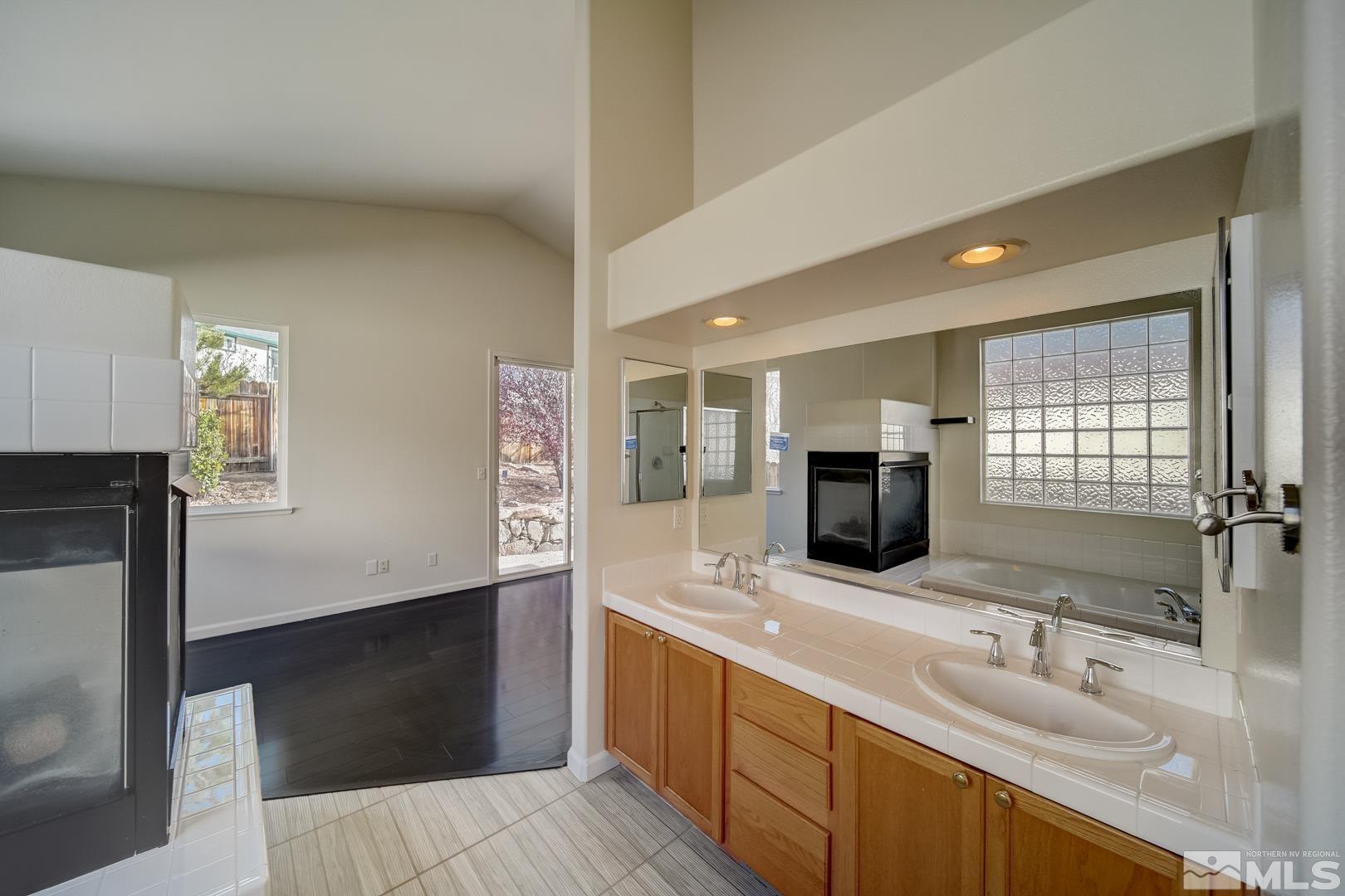 7560 Michaela Drive Reno, NV 89511 - Photo 30 of 32 a bathroom with double vanity and a large mirror