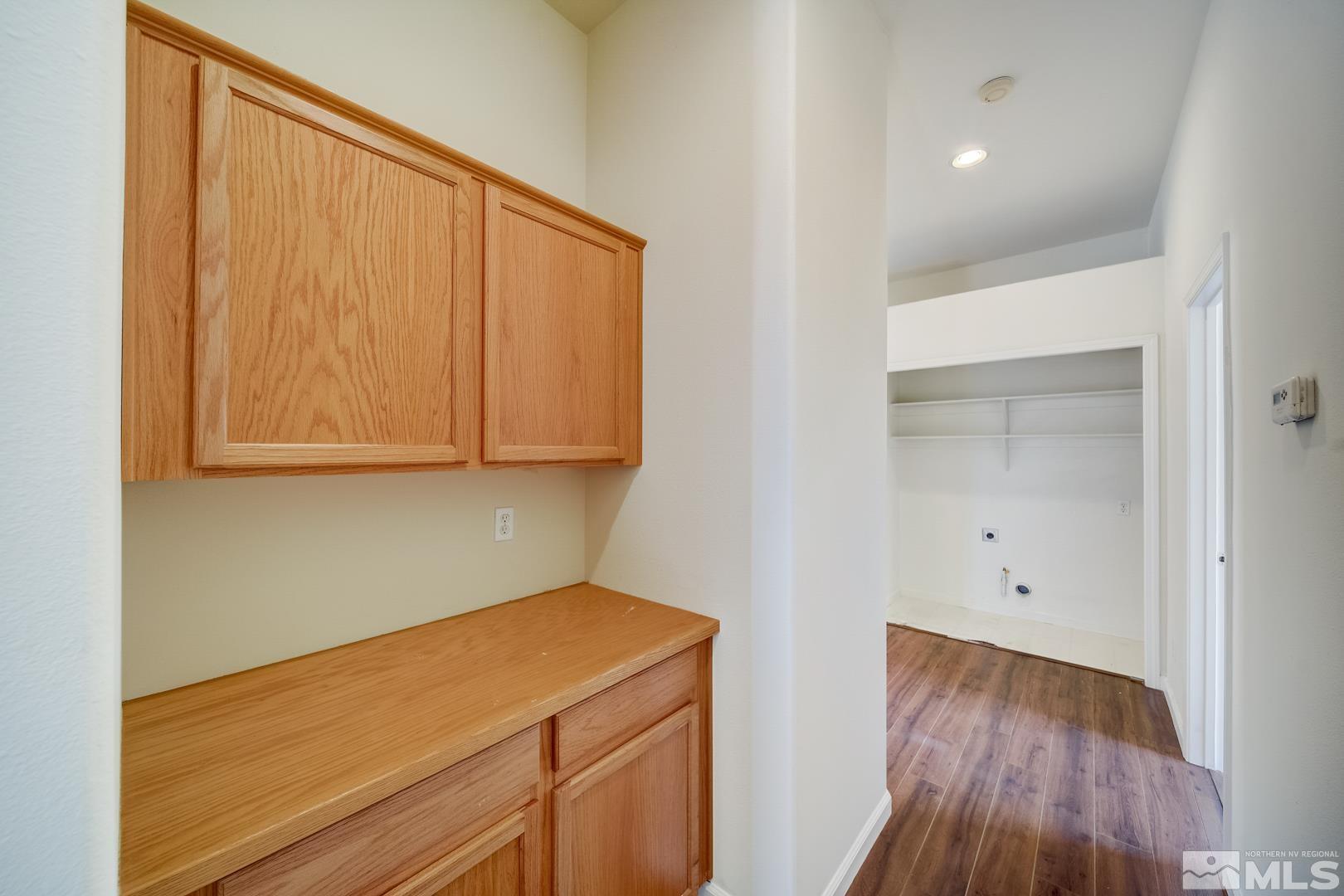 7560 Michaela Drive Reno, NV 89511 - Photo 31 of 32 a room with a wooden floor and cabinets