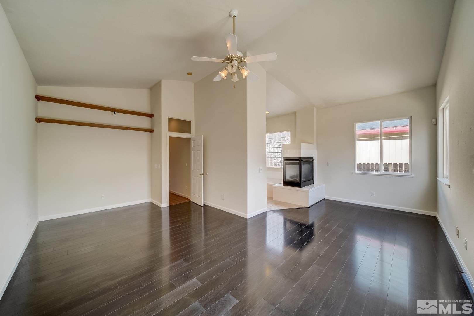 7560 Michaela Drive Reno, NV 89511 - Photo 7 of 32 an empty room with wooden floor and windows