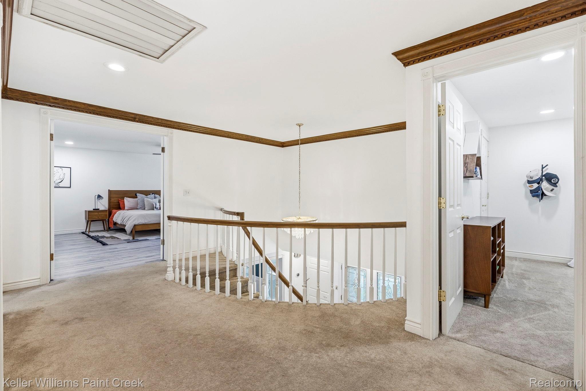 1675 North Kilburn Road Rochester, MI 48306 - Photo 32 of 48 Upper-level landing featuring neutral carpeting and white balusters with a wood-finish handrail