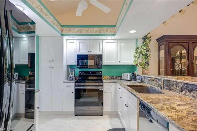 a kitchen with a sink stove and cabinets