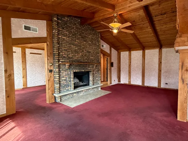 a view of empty room with a fireplace