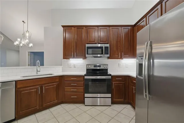 a kitchen with a sink and steel stainless steel appliances