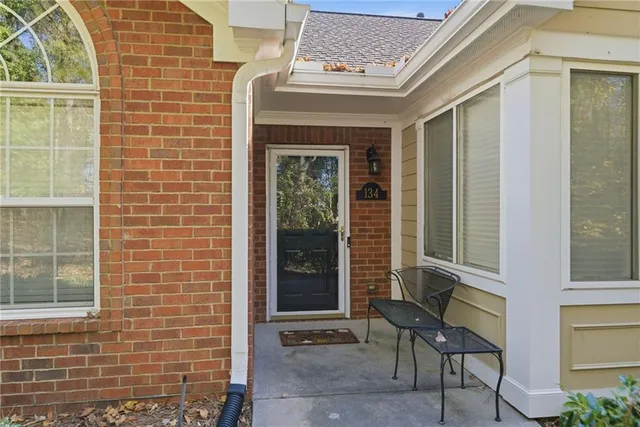 a view of front door of house with outdoor seating