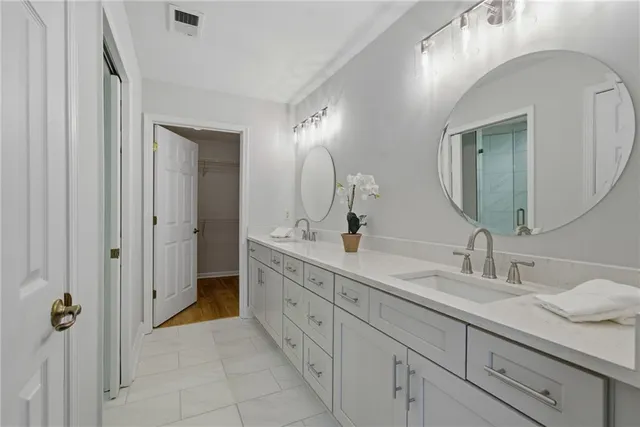a spacious bathroom with a double vanity sink mirror and