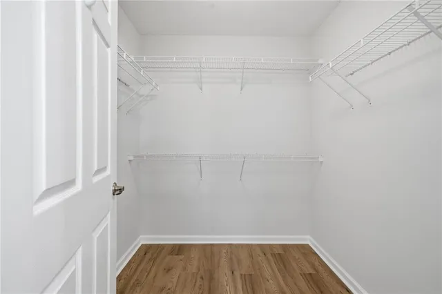 a view of a room with wooden floor