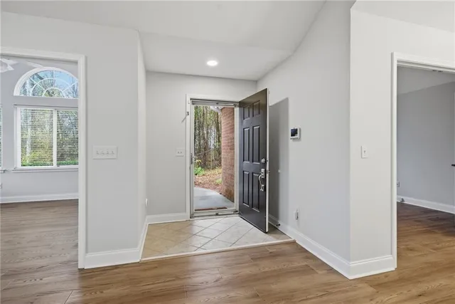 a view of entryway with wooden floor and windows