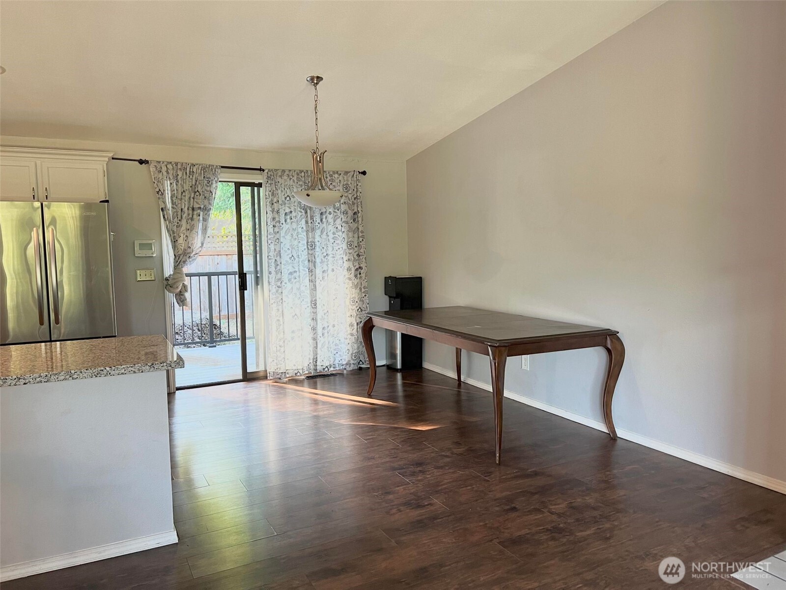 156 South 358th Street Federal Way, WA 98003 - Photo 13 of 35 a hallway with couches and a dining table with wooden floor