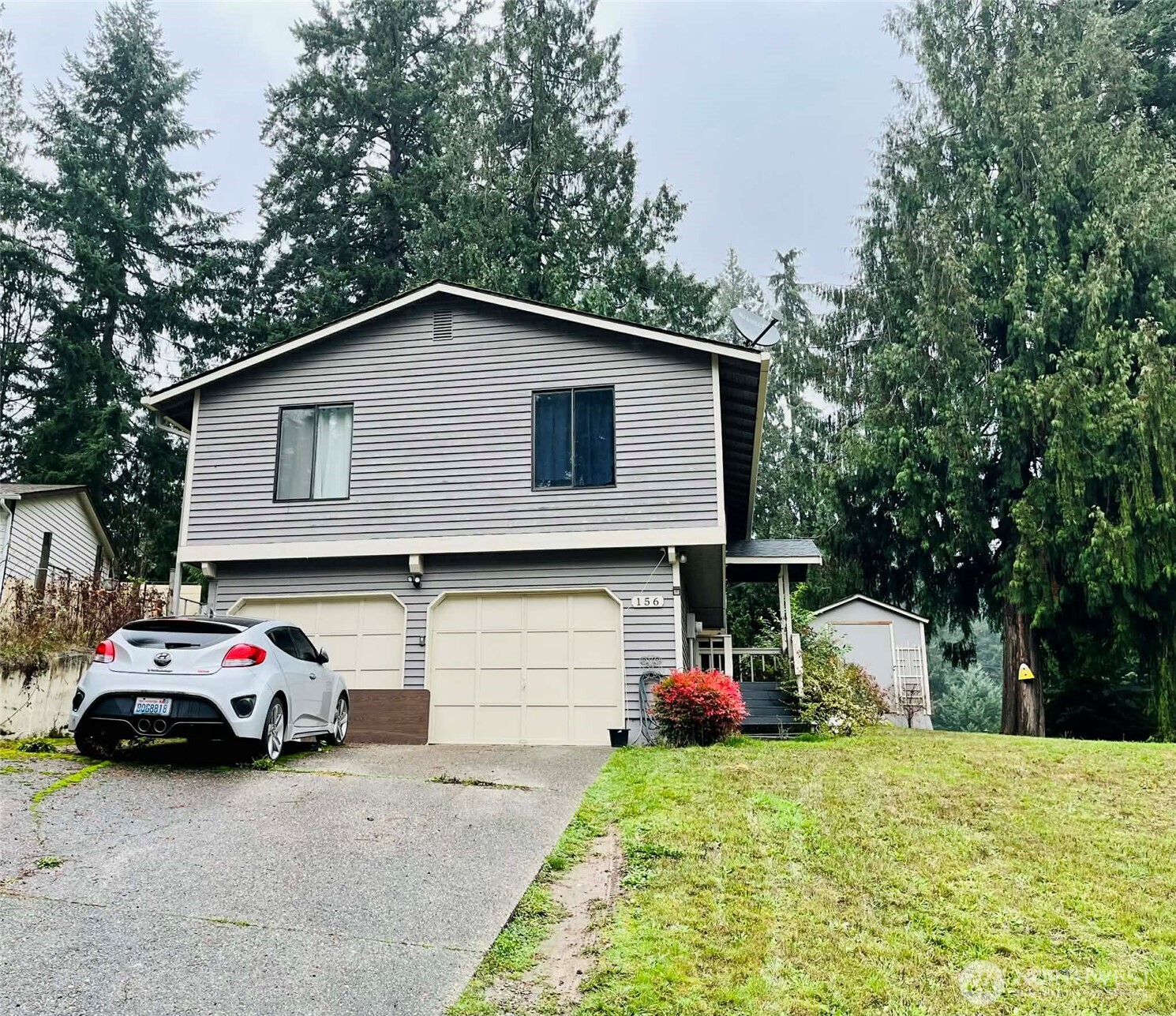 156 South 358th Street Federal Way, WA 98003 - Photo 3 of 35 a front view of a house with a yard and garage