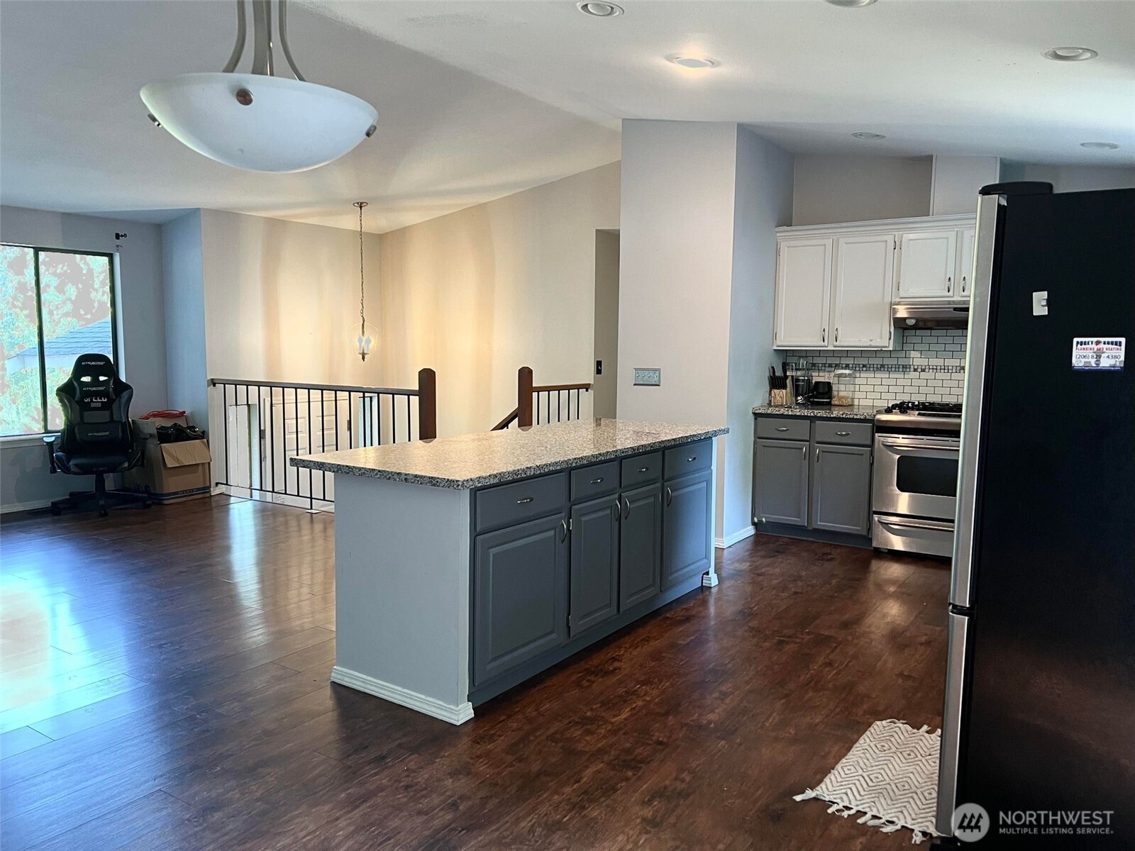 156 South 358th Street Federal Way, WA 98003 - Photo 10 of 35 a kitchen with kitchen island granite countertop wooden floors and a sink