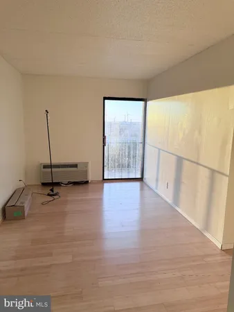 a view of a room with wooden floor and windows