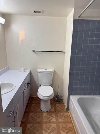 a bathroom with a sink a toilet and bathtub