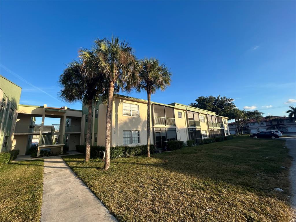 4147 Northwest 90th Avenue, Unit 206 Coral Springs, FL 33065 - Photo 1 of 37 a view of a house with a yard