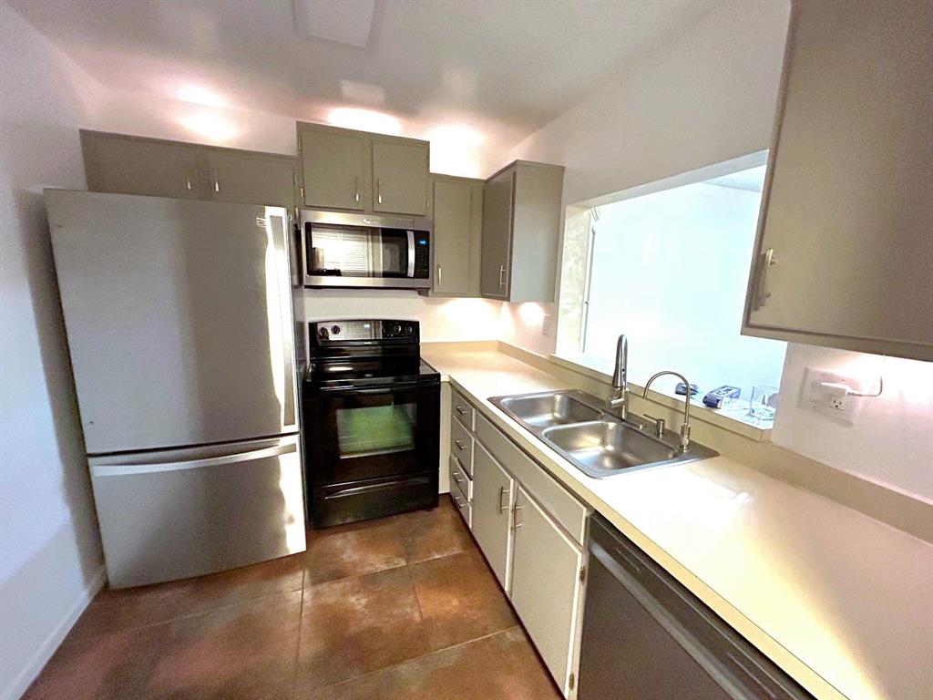 4147 Northwest 90th Avenue, Unit 206 Coral Springs, FL 33065 - Photo 14 of 37 a kitchen with a sink and stainless steel appliances