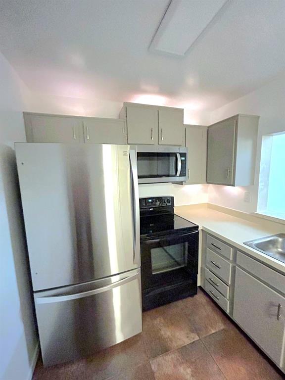 4147 Northwest 90th Avenue, Unit 206 Coral Springs, FL 33065 - Photo 17 of 37 a kitchen with a refrigerator and a sink