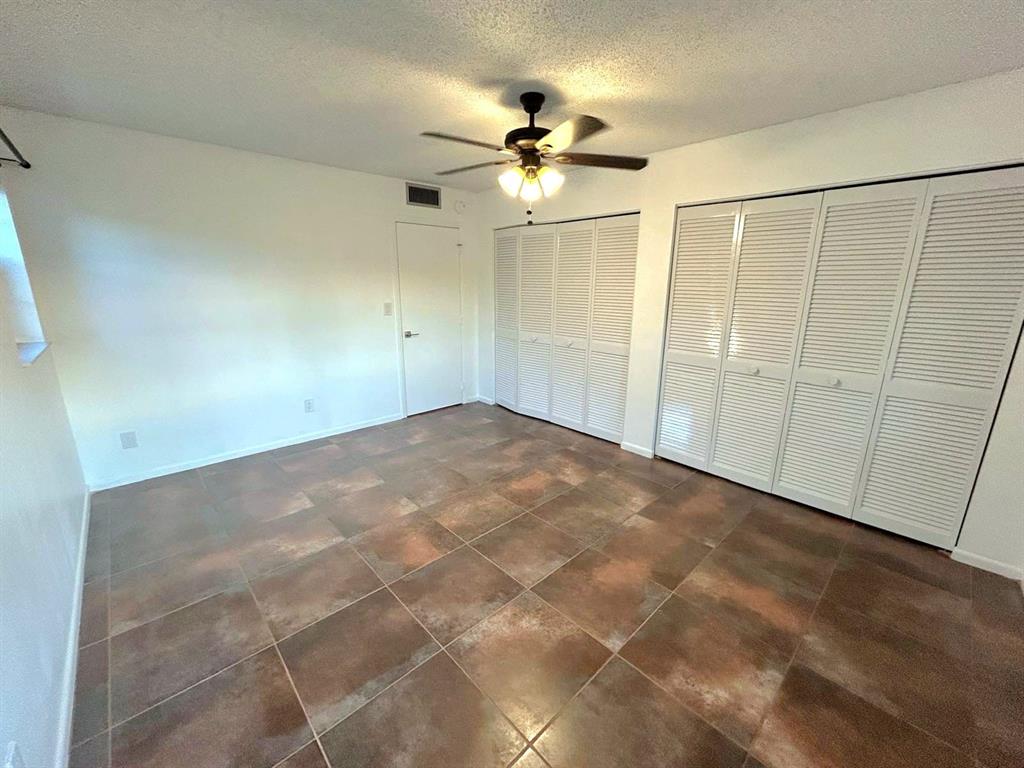 4147 Northwest 90th Avenue, Unit 206 Coral Springs, FL 33065 - Photo 20 of 37 an empty room with fan and entryway