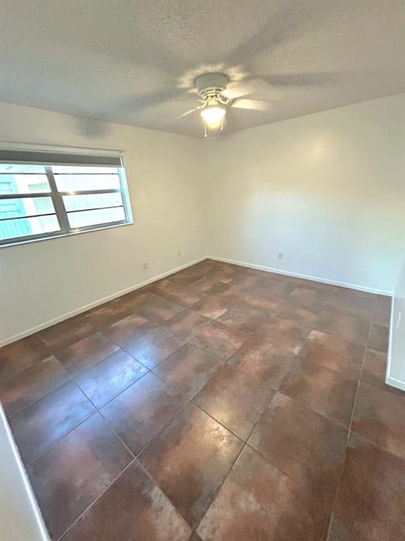 4147 Northwest 90th Avenue, Unit 206 Coral Springs, FL 33065 - Photo 22 of 37 en empty room with window and chandelier fan