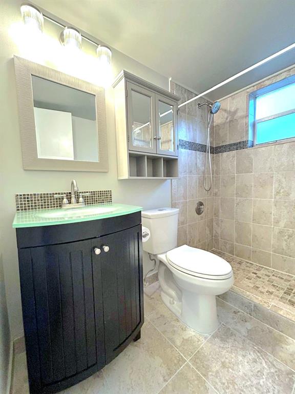 4147 Northwest 90th Avenue, Unit 206 Coral Springs, FL 33065 - Photo 29 of 37 a bathroom with a sink vanity mirror and toilet