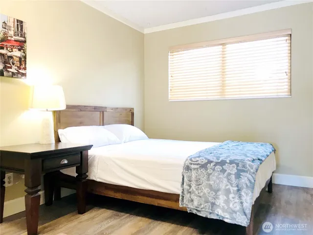 a bedroom with a bed and window