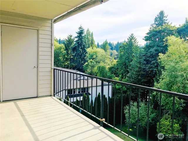 a balcony with trees in front of it