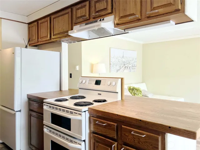 a kitchen with stainless steel appliances a stove and a refrigerator