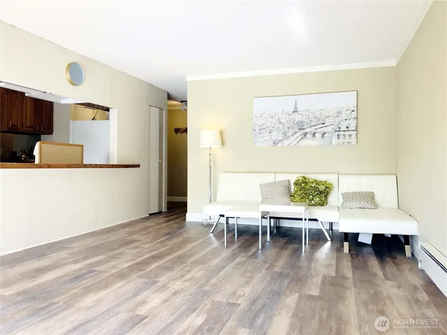a living room with couches and a coffee table with wooden floor