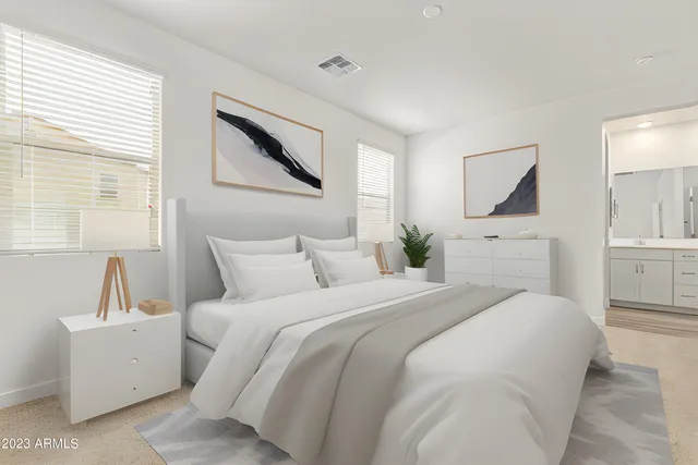 a bedroom with a large bed and a chandelier