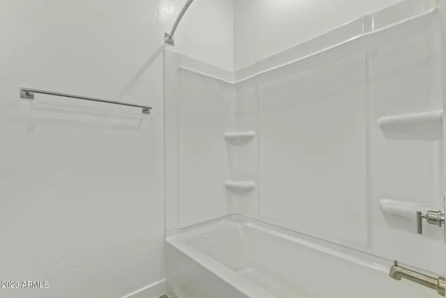 a bedroom with a bed and a night stand