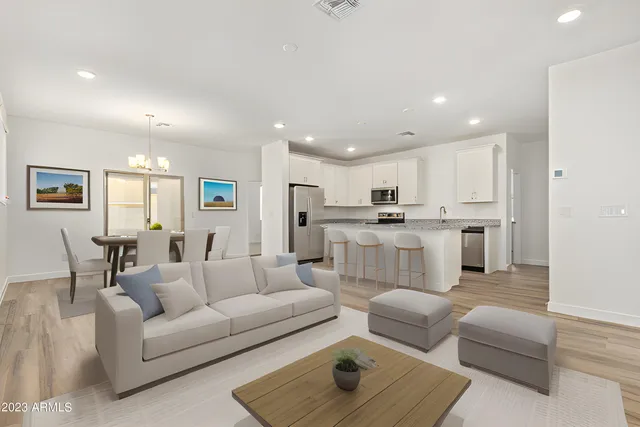 a living room with furniture and kitchen view