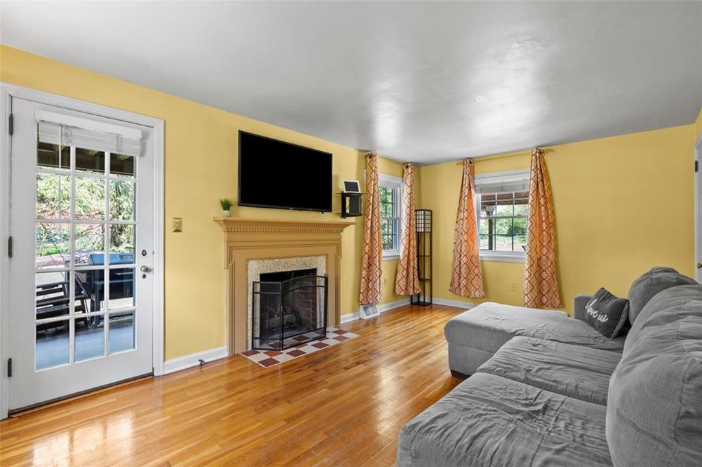 424 Thompson Run Road Pittsburgh, PA 15237 - Photo 13 of 31 a living room with furniture a fireplace and a flat screen tv