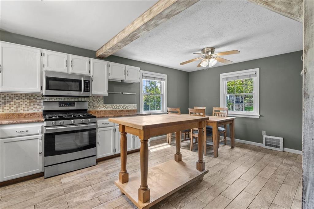 424 Thompson Run Road Pittsburgh, PA 15237 - Photo 8 of 31 a kitchen with kitchen island a dining table and chairs