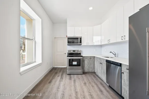 a kitchen with granite countertop a stove top oven and sink