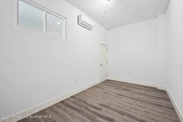 a view of a room with wooden floor