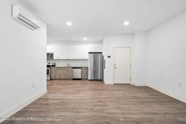 a view of a kitchen with a sink and dishwasher cabinets